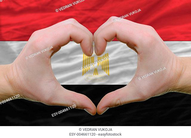 Heart and love gesture showed by hands over flag of egypt backgr