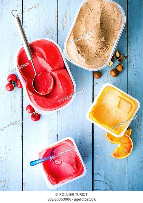 Punnets of different-flavored ice creams :blood orange, raspberry, hazelnut and cherry