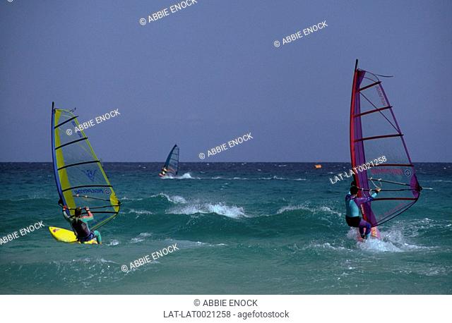 Jandia. Southern peninsula. Sea. Surf. Windsurfers. Colourful sails