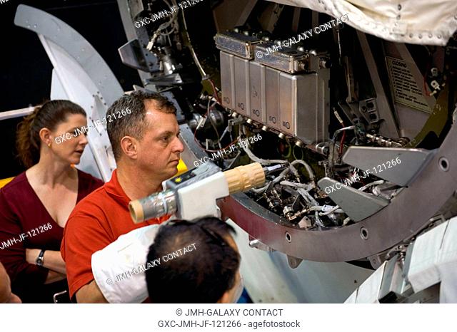 NASA astronaut T.J. Creamer and Japan Aerospace Exploration Agency (JAXA) astronaut Soichi Noguchi (mostly out of frame), both Expedition 2223 flight engineers