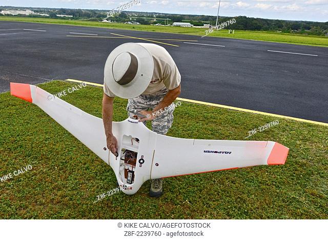 Instructor Gene Payson holds a fixed-wing RC planes at a small unmanned aircraft pilot training course at the Unmanned Vehicle University