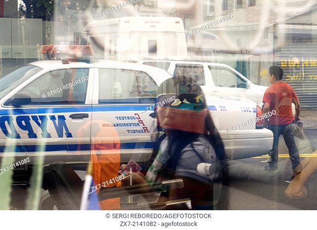 Reflection of a police car in Queens showcase . Queens is the largest neighborhood in New York , is a county also has to his term with an impressive array of...