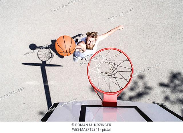 Man playing basketball on outdoor court