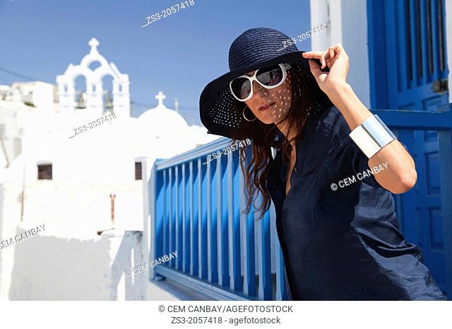 Woman posing in front of a church, Amorgos, Cyclades Islands, Greek Islands, Greece, Europe