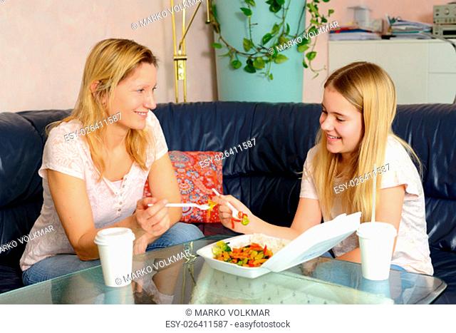 mother and daughter eating together fast food
