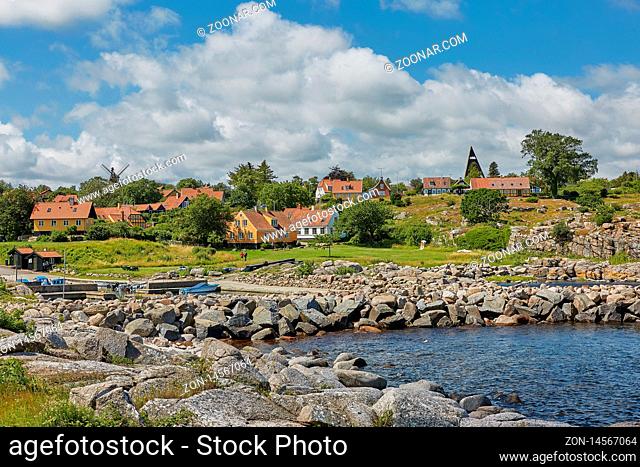 SVANEKE, DENMARK - JULY 4, 2017: View of village of Svaneke in Denmark and modern three-legged water tower designed by Jorn Utzonon