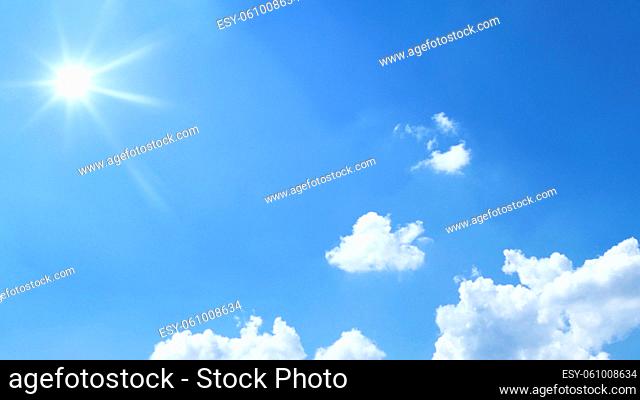 a bright blue sky with sun and clouds background