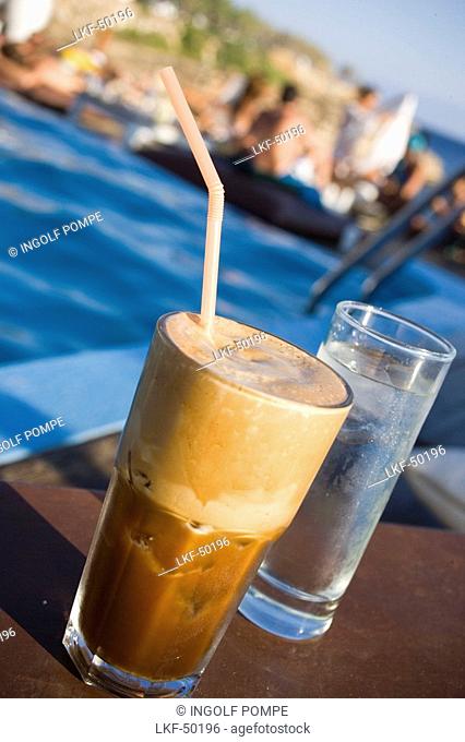 Frappe served with a glass of water in the Goya Beach Bar, the only beach bar with pool, Paranga Beach, Mykonos, Greece