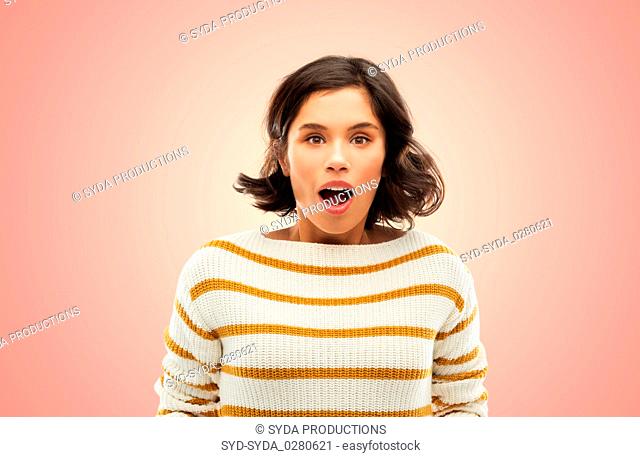 surprised young woman in striped pullover