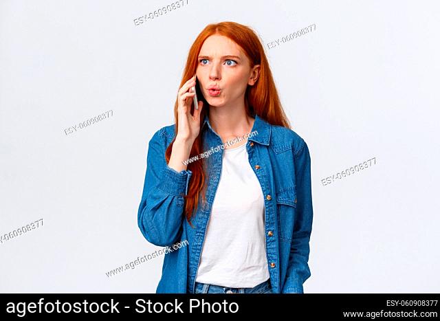 You say what. Intense and frustrated, confused redhead woman getting tensed and distressed hearing some bad news on phone
