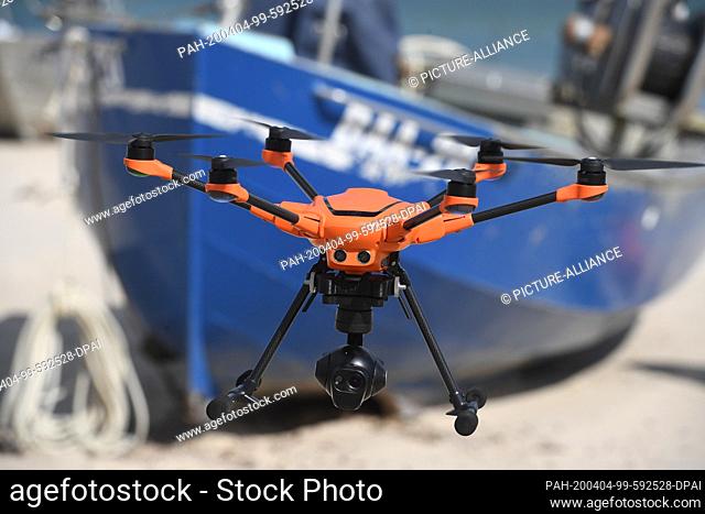 04 April 2020, Mecklenburg-Western Pomerania, Baabe: A rescuecopter (drone) of the fire brigade is used in the Amt Mönchgut-Granitz on the island of Rügen on...