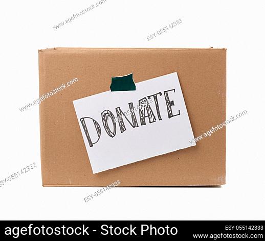 brown cardboard box with a pasted white sheet and the inscription donate on a white background, help concept