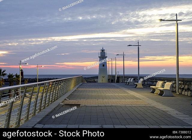 Sunrise with lighthouse at the harbour pier in Porto Maurizio, Imperia, Liguria, Italy, Europe