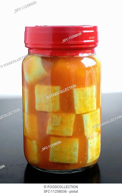 A jar of marinated tofu