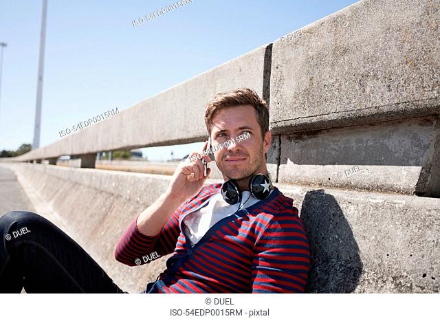 Man talking on cell phone on city street
