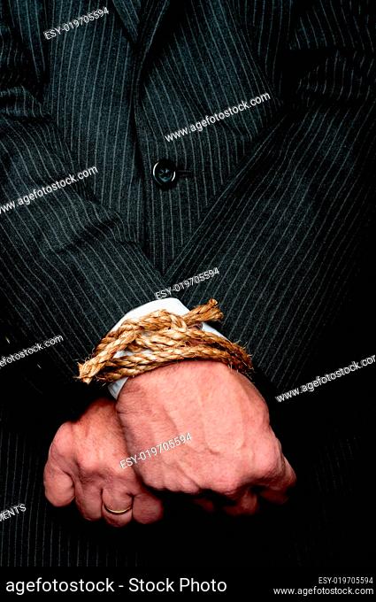 business man with his hands tied infront