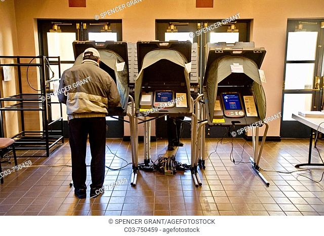 A voter uses an electronic voting machine on Election Day at a polling place in San Juan Capistrano, CA, USA