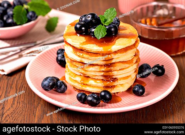Pancakes with fresh strawberries, blueberries and syrup