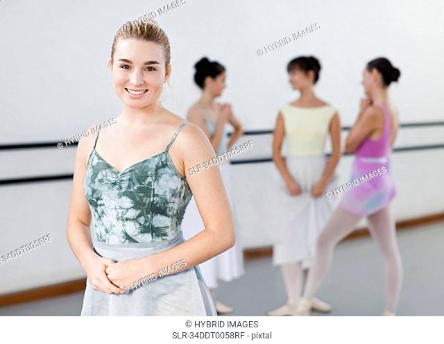 Smiling ballet dancer in studio
