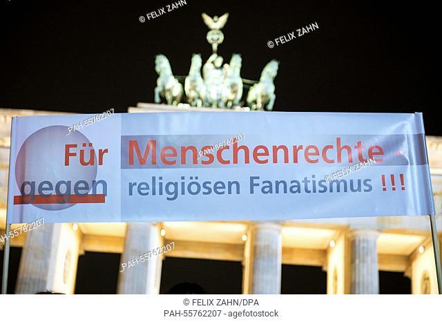 Activists hold up a banner that reads 'for human rights against religious fundamentalism' in front of the Brandenburg Gate in Berlin,  Germany, 10 February 2015