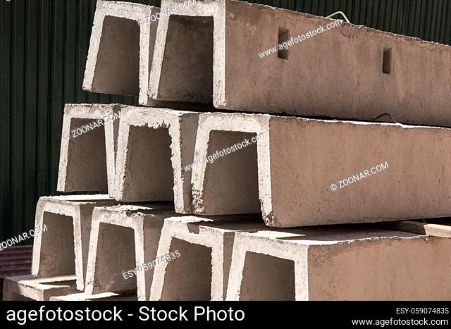 new concrete blocks for drainage, stacked in a row. building material