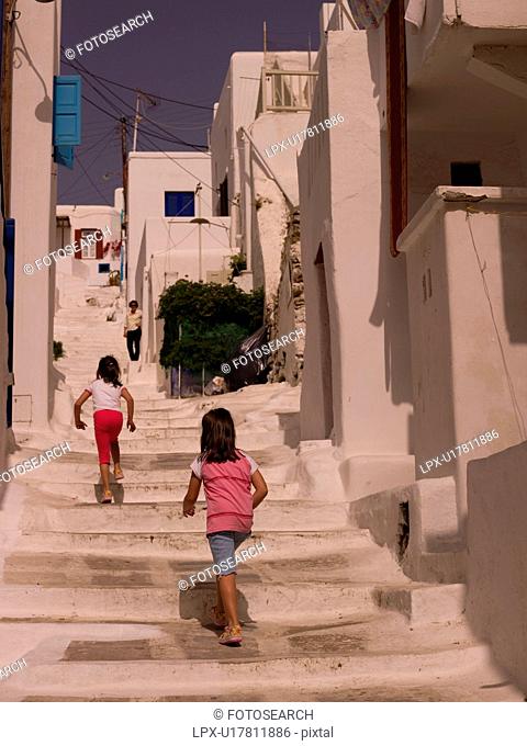 Children climbing stairs in Mykonos Greece