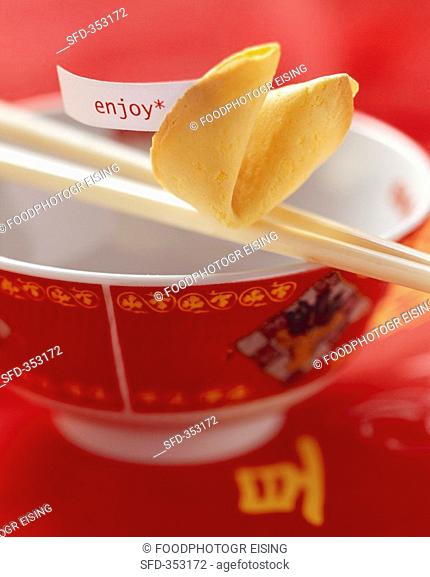 Asian bowl with chopsticks and fortune cookie