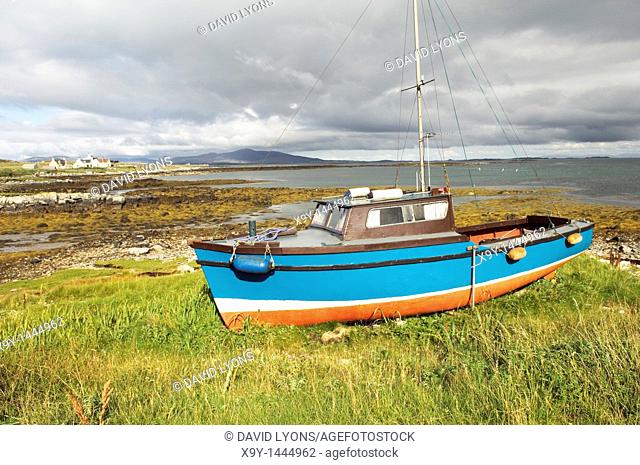 Fishing boat and cottages on island of Berneray in the Sound of Harris between North Uist and Harris  Outer Hebrides, Scotland