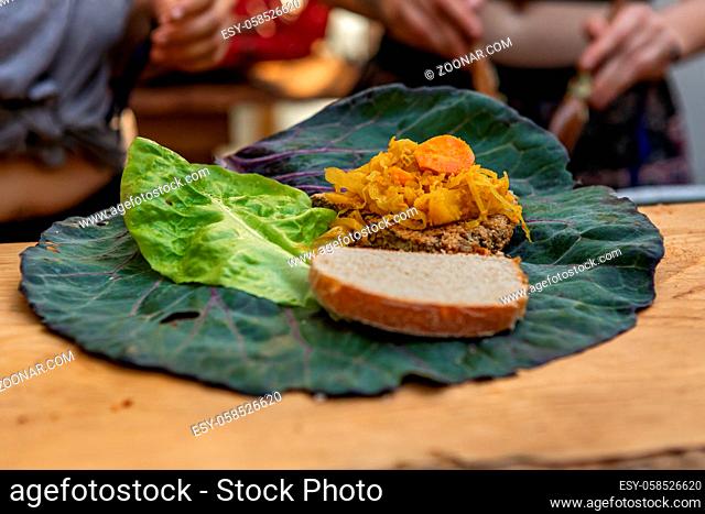 A close up selective focus shot with copy space on freshly prepared food with, wholemeal bread served on a collard green and romaine lettuce leaf