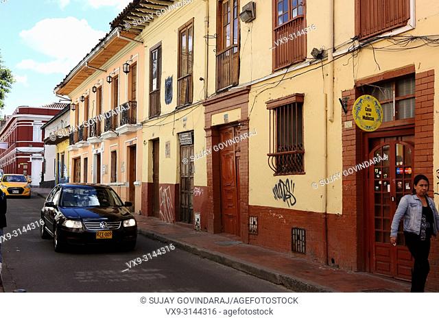 Bogotá, Colombia - May 28, 2017: Traffic drives through the old town area of La Candelaria in the Andean Capital city. Most buildings in the area go back to the...