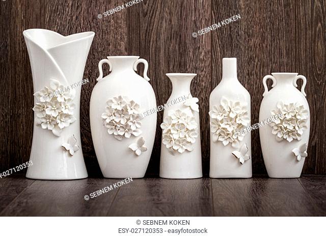 Different decorative white vases with 3d flower and butterfly designs