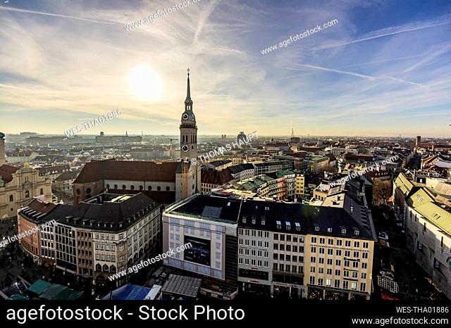 Germany, Munich, cityscape with St. Peter's church at dusk