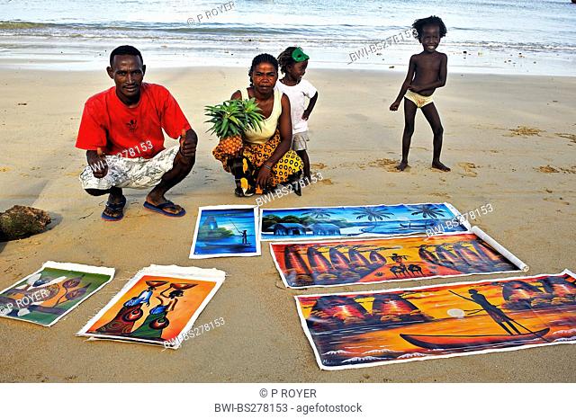 paintings for sale lying on sandy beach, Madagascar, Nosy be