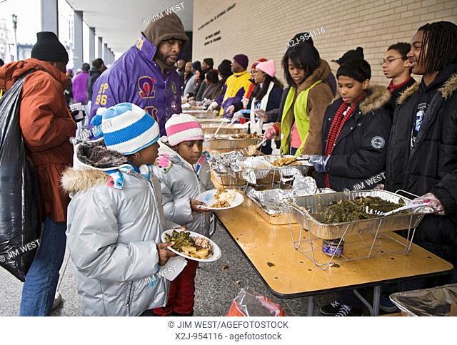 Washington, DC - Volunteers serve food to the hungry at an outdoor soup kitchen  The volunteer project was one of many Martin Luther King Day community service...