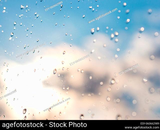 Water drops of rain on blue glass background. Rain drops on window. Shallow DOF