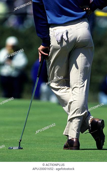 Golfer leaning on his golf club