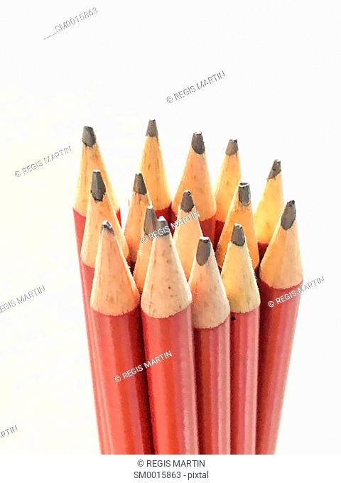 Bunch of red lead pencils against a white background
