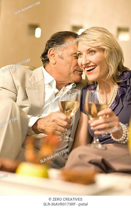 Smiling couple having wine together