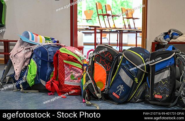 15 July 2021, Hessen, Wiesbaden: School bags stand in front of an empty classroom at Robert Schumann Elementary School. For hundreds of thousands of pupils