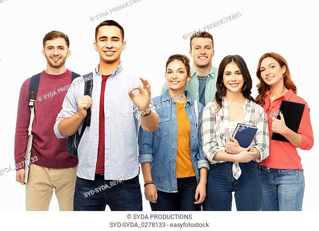 group of smiling students showing ok hand sign