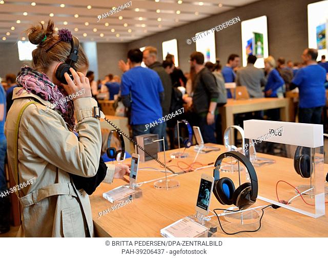 A customer listens to music in the Apple Store in Berlin,  Germany, 03 April 2013. The first Apple Store in Berlin opened to a crowd of Apple fans on Friday