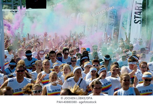 Participants in the Color Run throw colourful powders into the air in Hanover, Germany, 07 July 2013. Several thousand participants took part in a 5 km run...