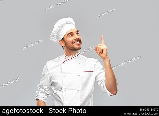 happy smiling male chef pointing finger up