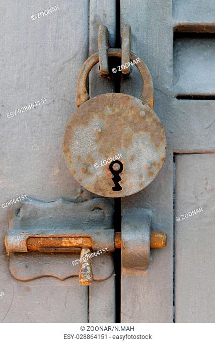 old vintage padlock - closed metal door
