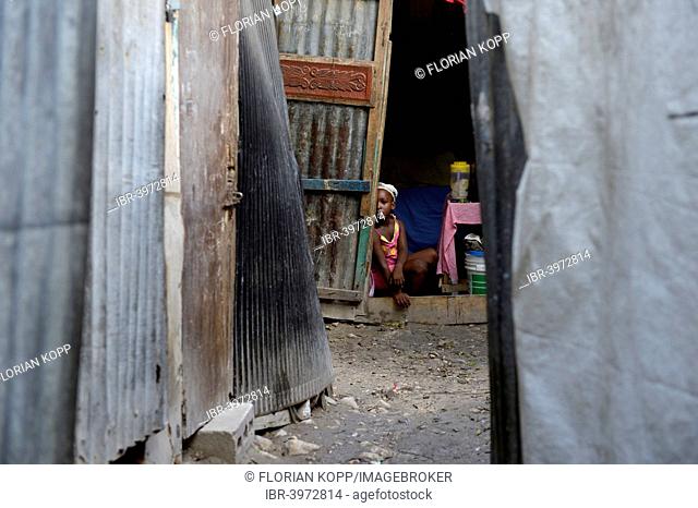 Girl in the entrance of a shack, Camp Icare for earthquake refugees, Fort National, Port-au-Prince, Haiti