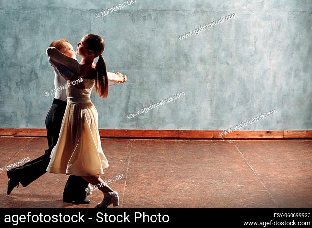 Young couple boy and girl dancing in ballroom dance Viennese Waltz