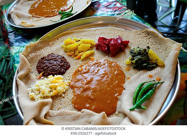 Injera made of tef and served on a big plate with different kinds of vegetables, Ethiopia, East Africa
