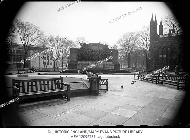 A view of the public gardens north of St Thomas' Church, with a partial view of the church on the right, focussing on the war memorial (The Response) in the...