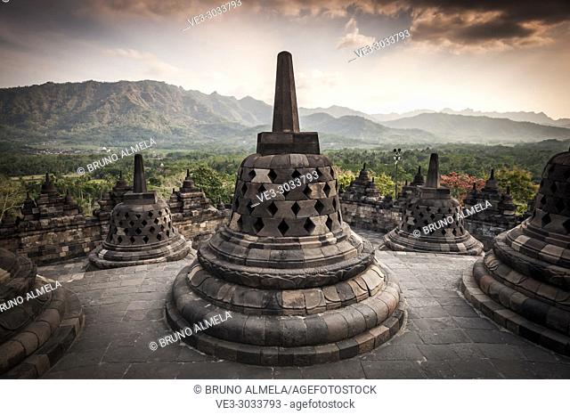 Unroofed pyramid of Borobudur Temple, crowned by bell-shaped stone domes (Magelang Regency, Central Java, Indonesia)