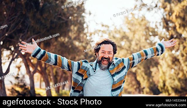 Crazy overjoyed adult man with arms outstretched smile and laugh alone in banner header image. Happiness and joyful people concept lifestyle
